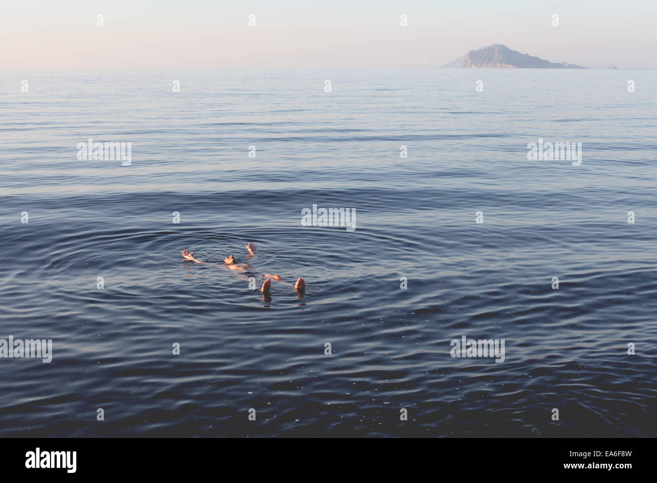 Man floating in sea, Lipari, Aeolian Islands, Italy Stock Photo