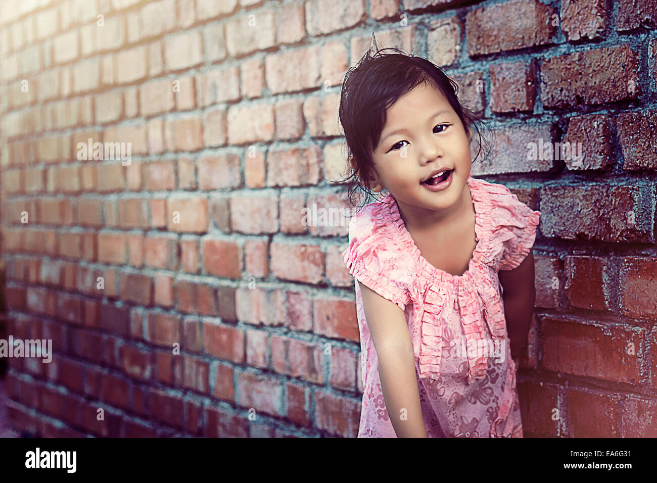 Portrait of girl leaning against wall Stock Photo