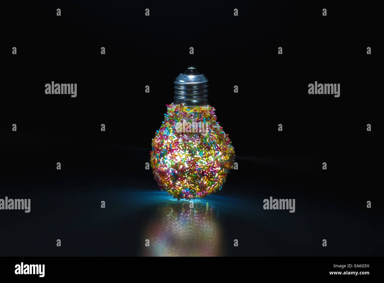 Light bulb covered in multicoloured sprinkles Stock Photo