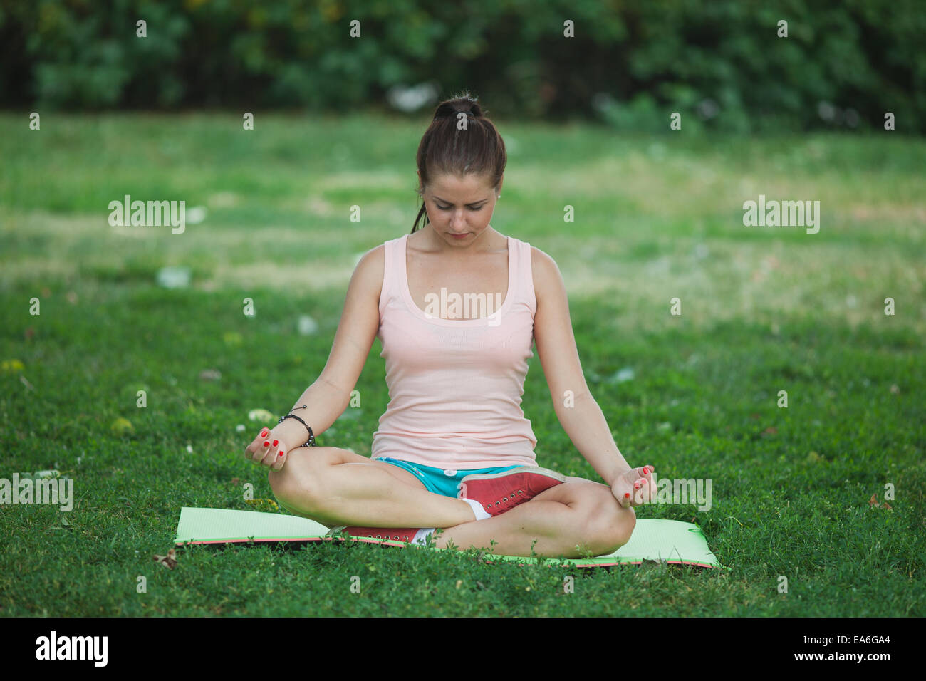 young girl sitting in the lotus position Stock Photo - Alamy