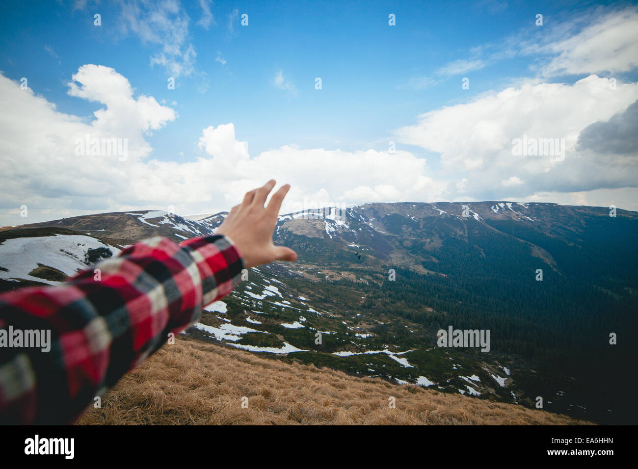 Scenic landscape with human hand in foreground Stock Photo