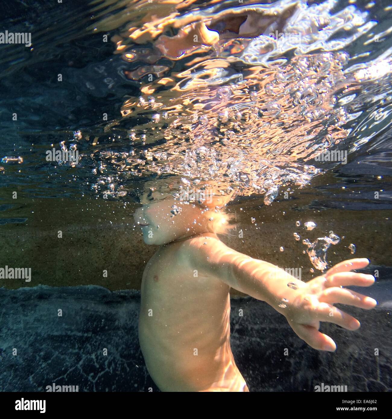 Boy swimming underwater Stock Photo