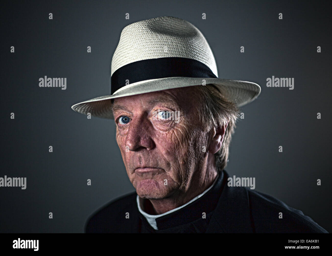 A white european male age 50 plus wearing religious clothing and smoking a cigarette Stock Photo