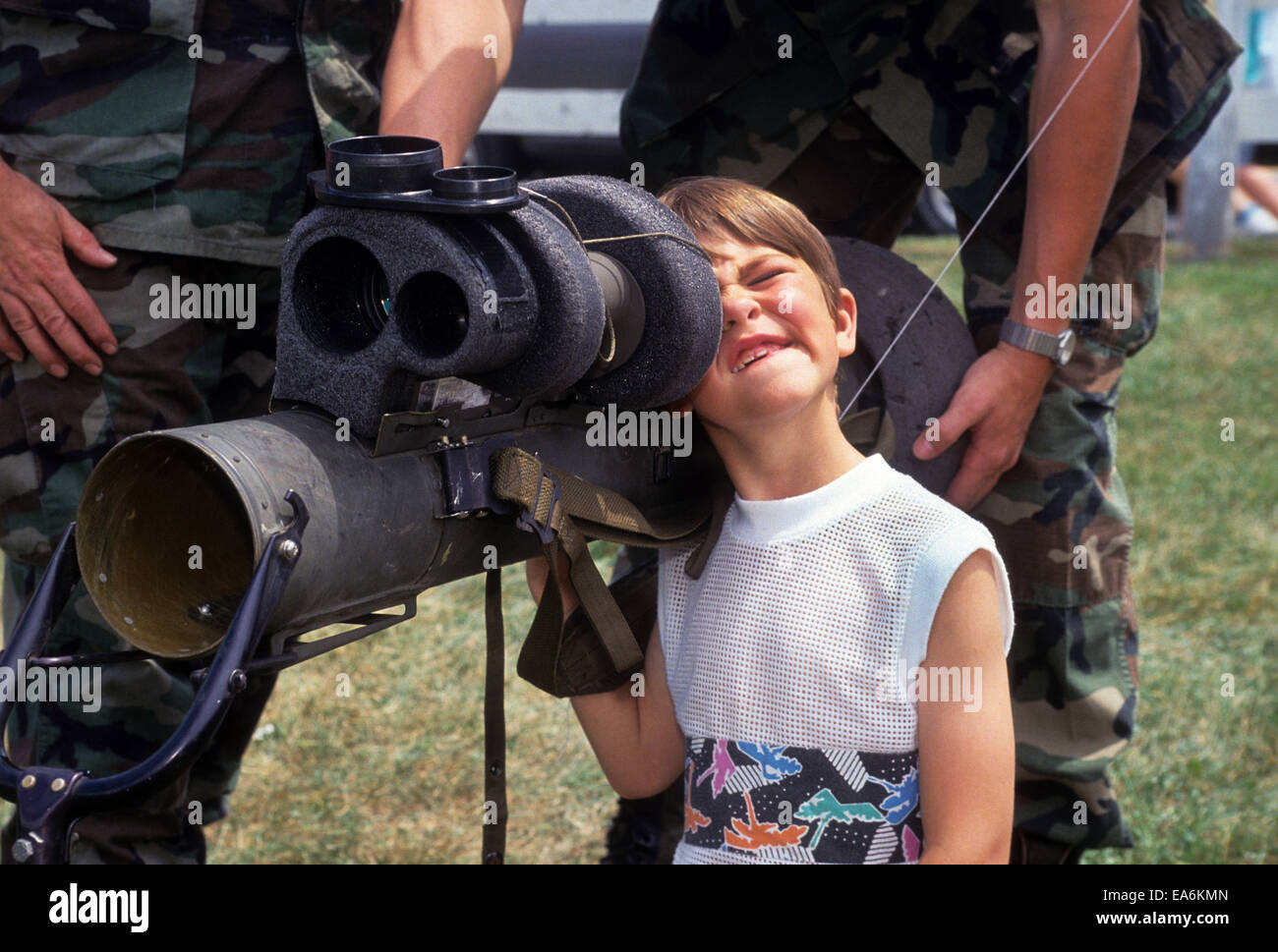 Curious boy at a military display. Stock Photo