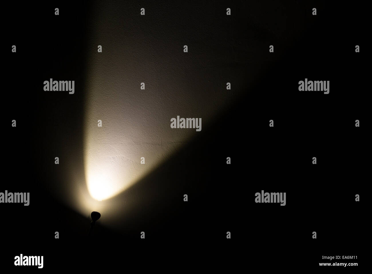 Dark Wall Illuminated from the Left Corner Spotlight Lamp, black