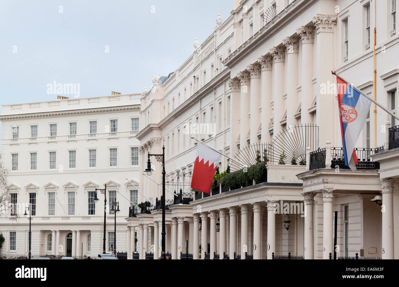 A terrace of houses in Belgravia London, many occupied by foreign embassies or consulates. This is Belgrave Square. Stock Photo
