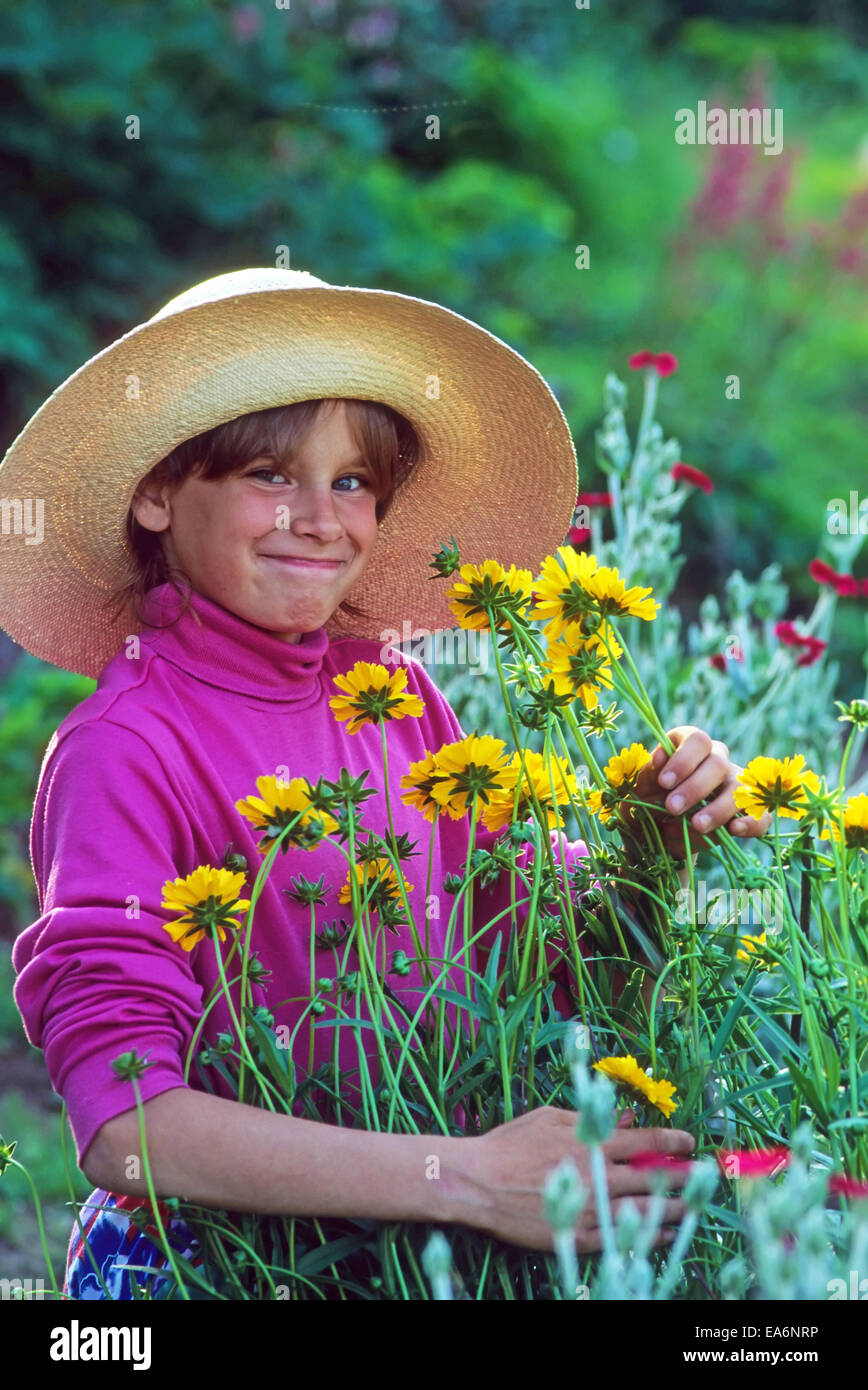 wide-brim straw hat picking flowers 
