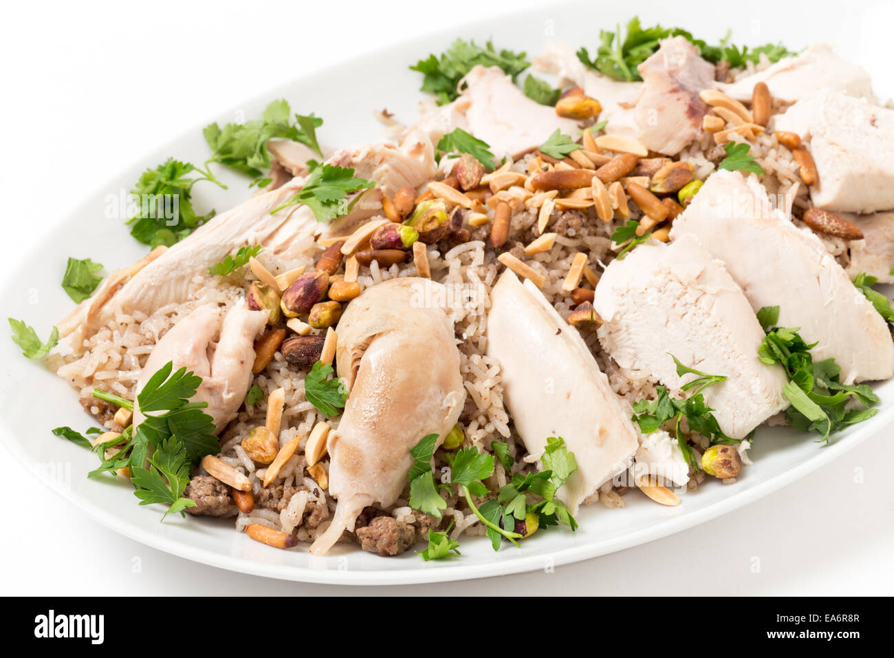 Chicken with spiced rice and nuts, garnished with parsley, a Lebanese celebratory dish. Stock Photo