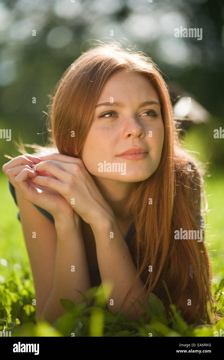 girl lying on the grass and smiling Stock Photo - Alamy