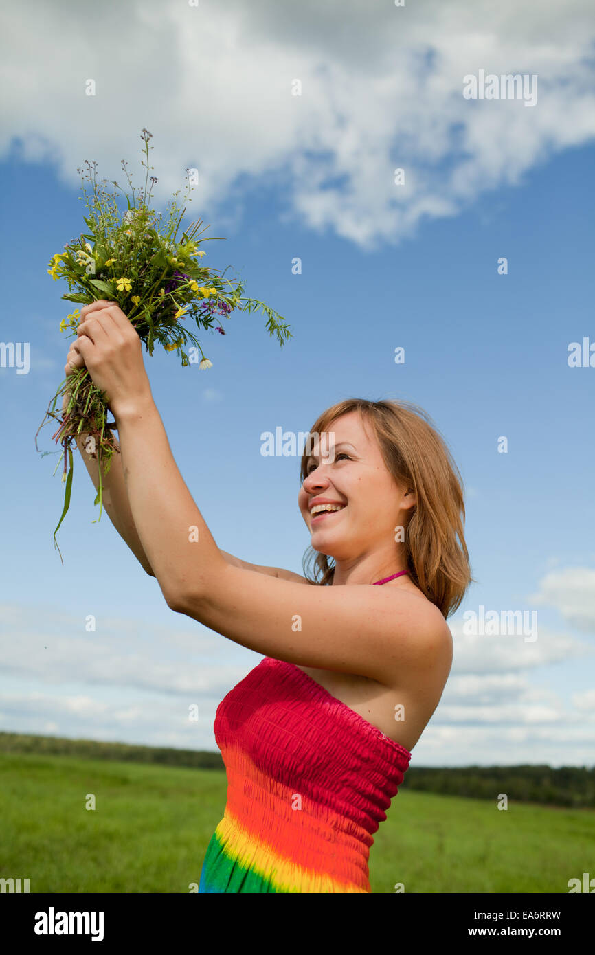 girl with a bouquet of wild flowers Stock Photo - Alamy