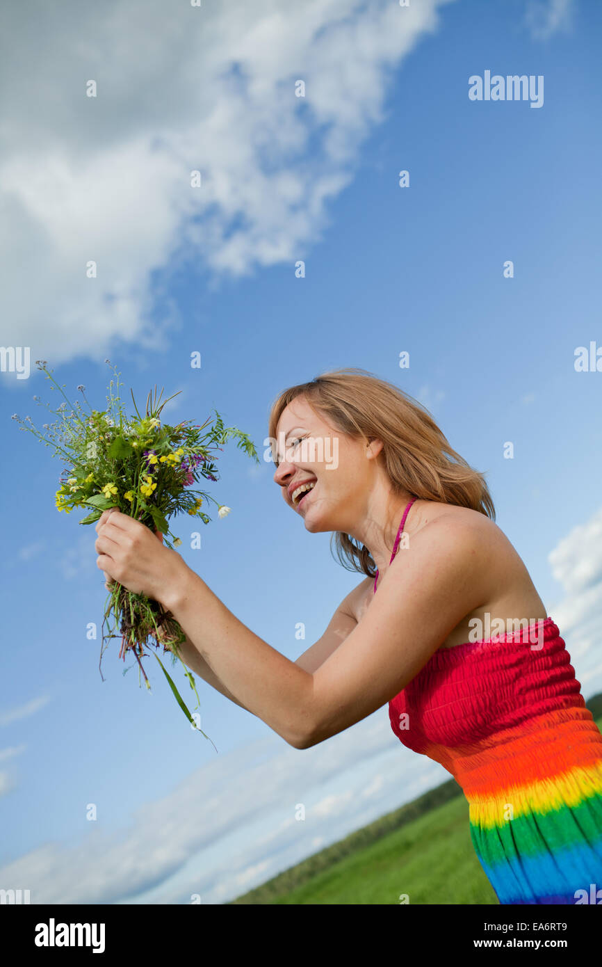 girl with a bouquet of wild flowers Stock Photo - Alamy
