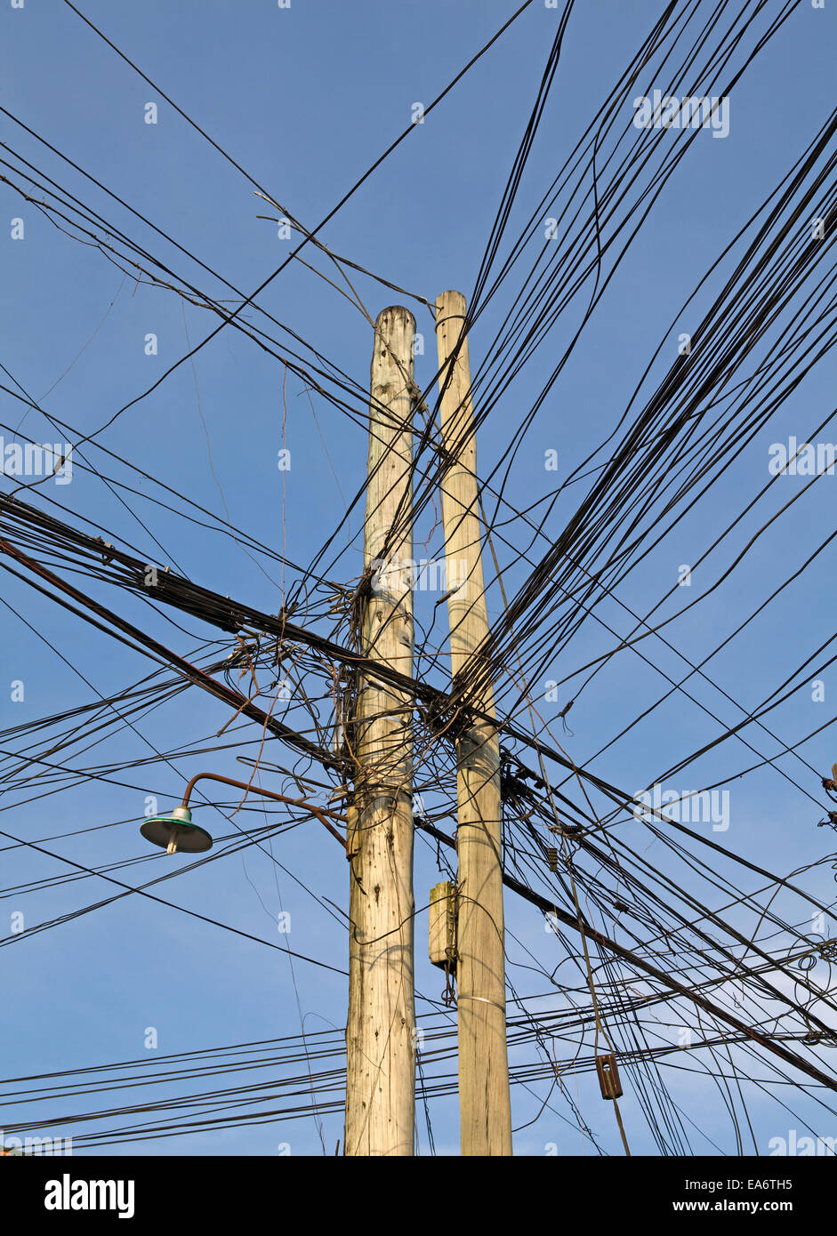Tangled telephone and electric lines. Stock Photo