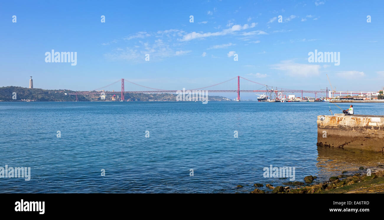 25 de Abril Bridge. One of the largest suspension bridges in the world. Connects Lisbon to Almada over the Tagus River. Portugal Stock Photo