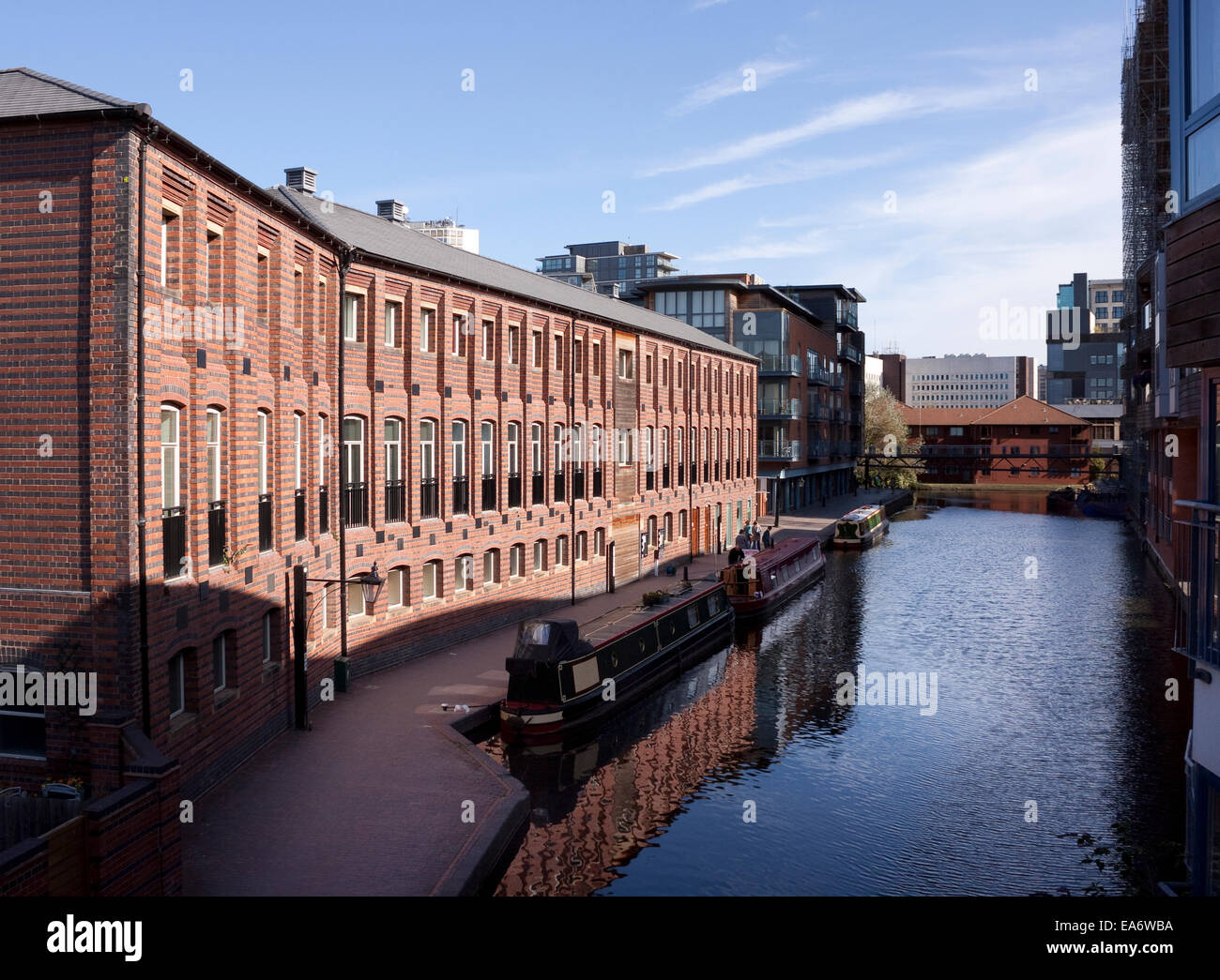 Canal and modern canalside architectural development Birmingham UK with Birmingham and Worcester Canal in the foreground looking Stock Photo