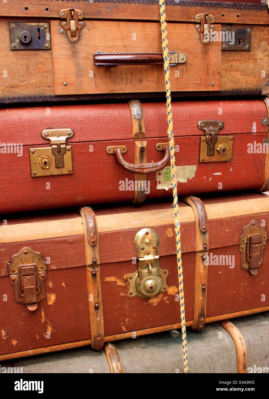 A stack of traditional packed suitcases, bound together with cord - on a platform of the West Somerset Railway in Minehead Stock Photo