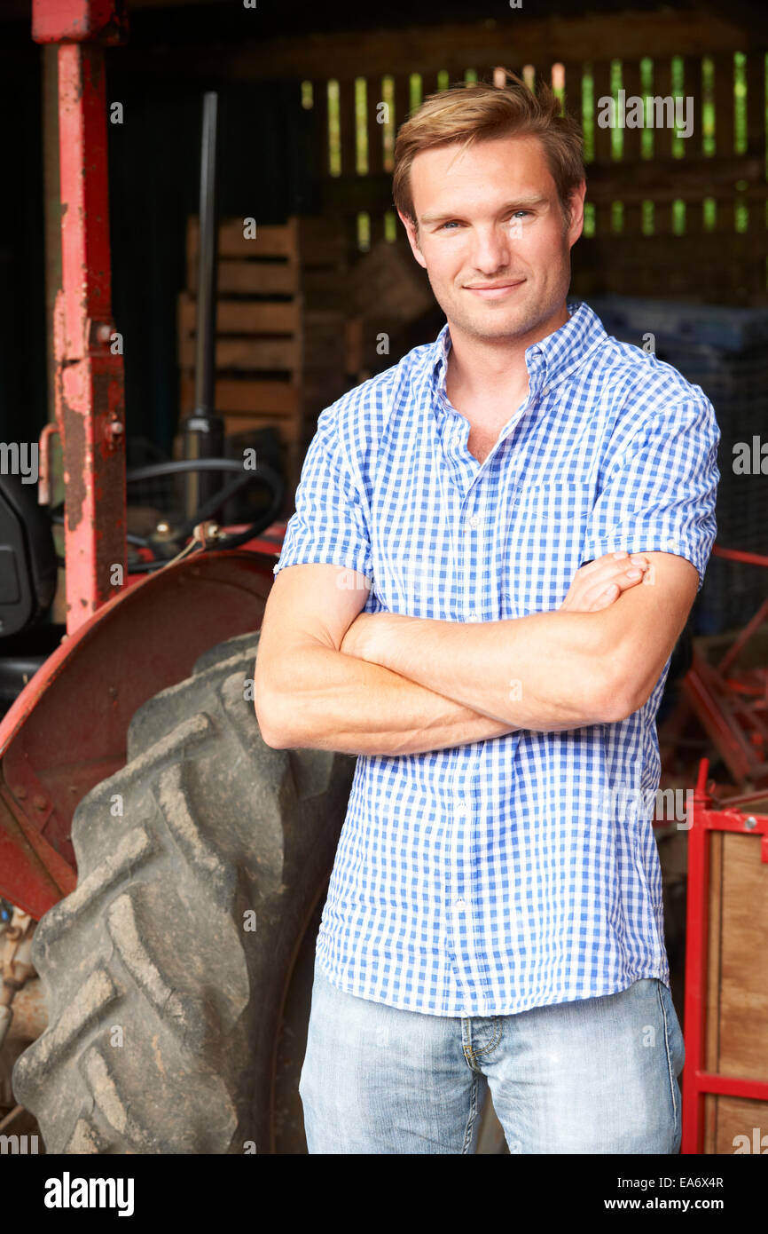 Portrait Of Farmer With Old Fashioned Tractor Stock Photo