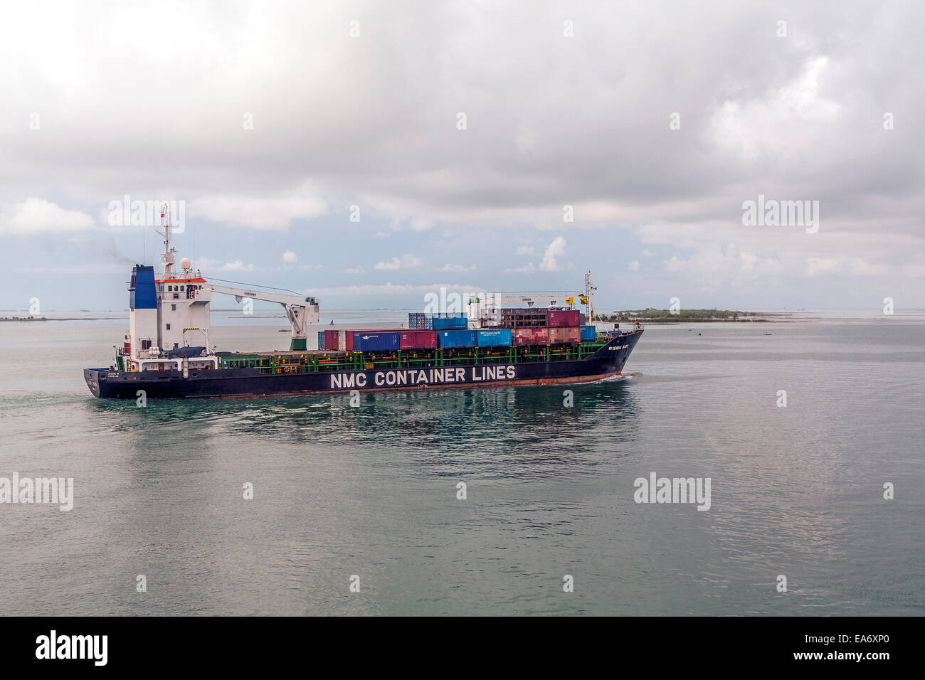 A loaded container cargo ship at sea makes its way out of Cebu Harbor in the Philippines. Stock Photo