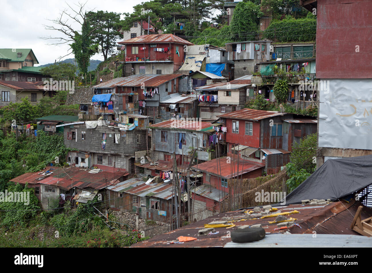Squatter homes in Baguio City, Philippines are perched on a mountain side. Stock Photo