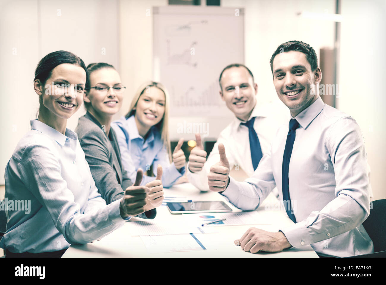 business team showing thumbs up in office Stock Photo - Alamy