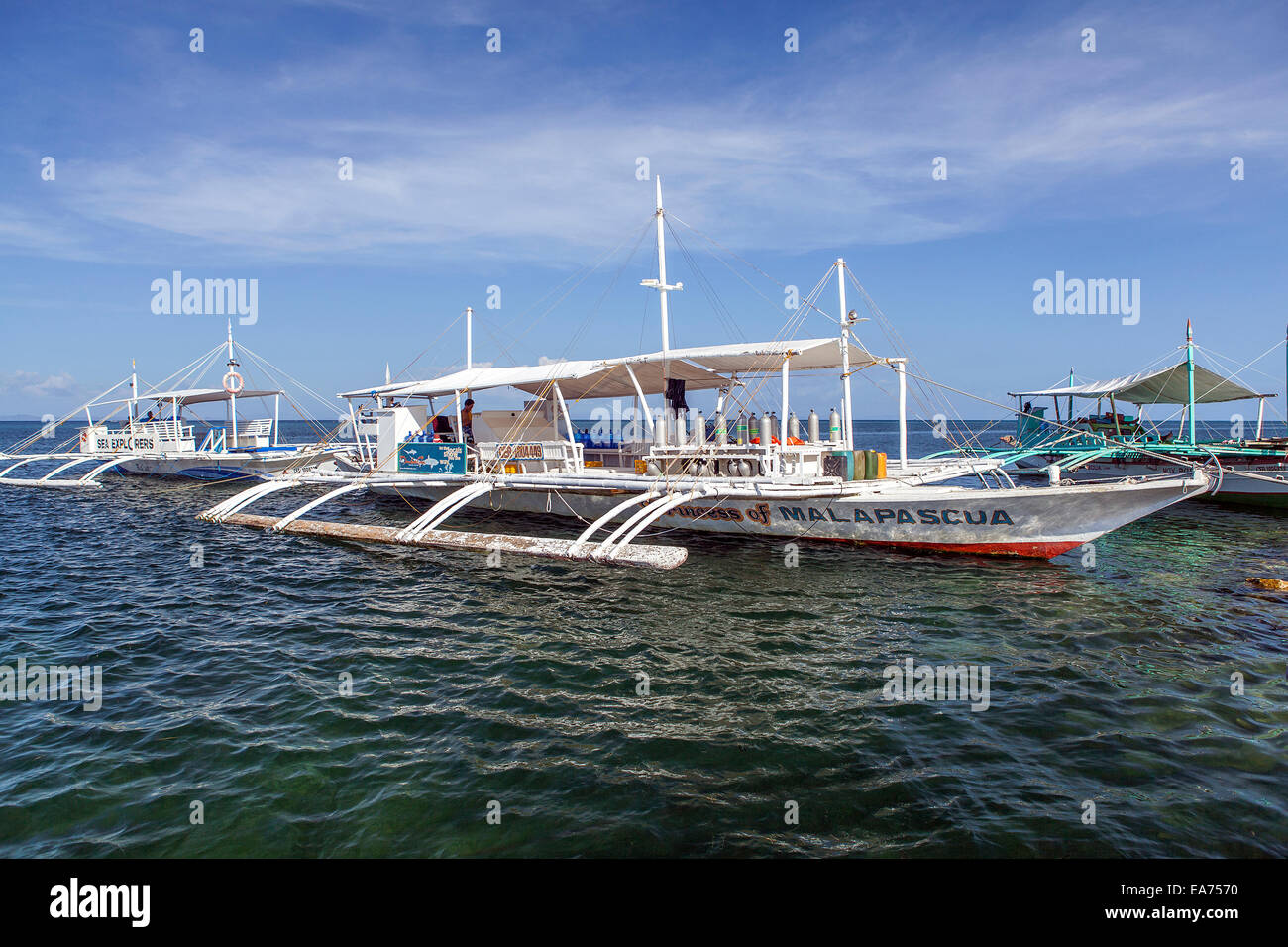 Outrigger scuba diving boats at dock in Daanbantayan, Cebu Island, Philippines. This is a remote and popular diving location. Stock Photo