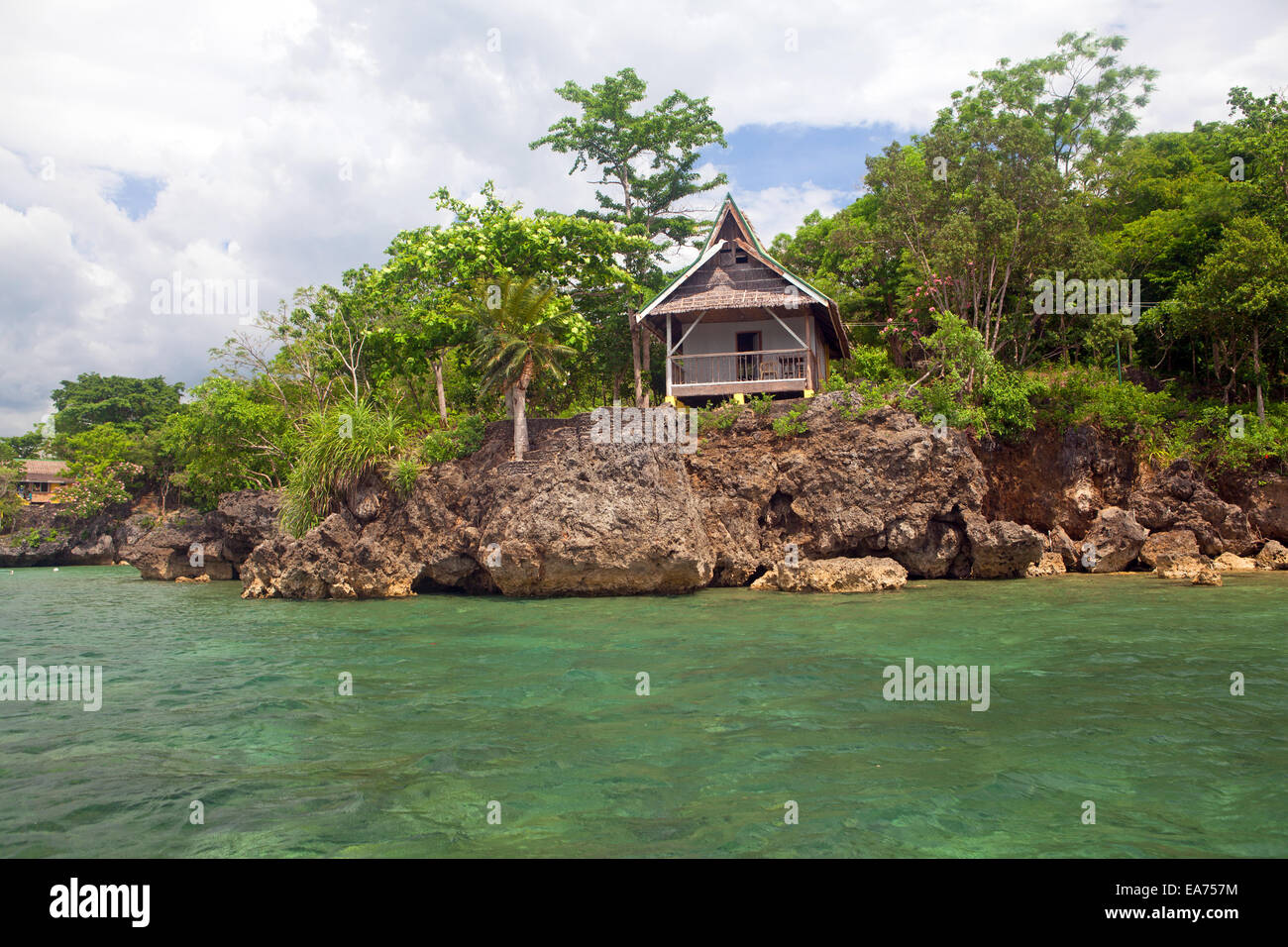 Guimaras Islands, Philippines - A rustic cottage perched on top of a limestone coral reef overlooks the Panay Gulf. Stock Photo