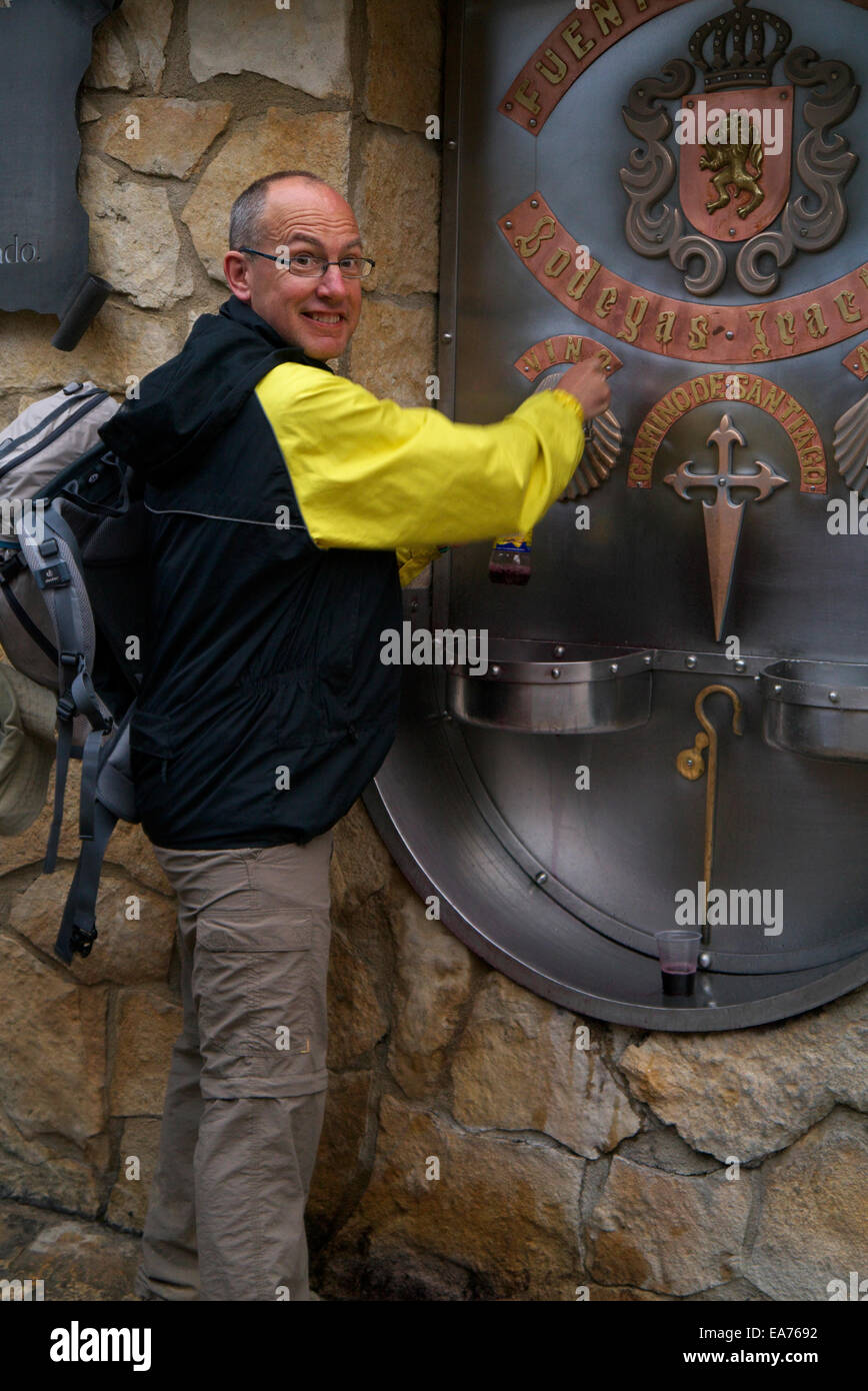 Bodegas Irache Wine Fountain Navarra Spain, on the Camino De Santiago De Compostela. Pilgrim taking a free wine sample. Stock Photo