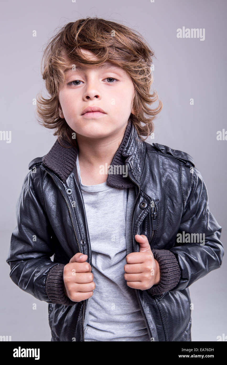Fashion little boy wearing a leather jacket Stock Photo Alamy
