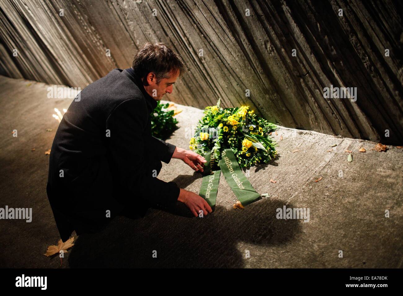 Berlin, Germany. 7th Nov, 2014. A man lays a flower wreath to a monument at Berlin's Grunewald train station during a memorial activity for the Crystal Night in Berlin, Germany, on Nov. 7, 2014. Some 100 middle school students and students from the local police school took part in the memorial activity on Friday to commemorate the 76th anniversary of the Nazi's 'Kristallnacht' (Crystal Night, Night of Broken Glass) in 1938, at Berlin's Grunewald train station, one of the major sites of deportation of the Berlin Jews during World War II. Credit:  Zhang Fan/Xinhua/Alamy Live News Stock Photo
