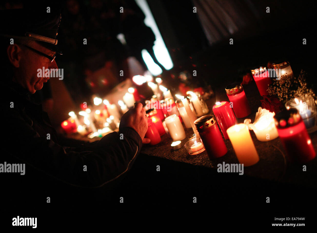 Berlin, Germany. 7th Nov, 2014. A policeman lights a candle during a memorial activity for the Crystal Night at Berlin's Grunewald train station in Berlin, Germany, on Nov. 7, 2014. Some 100 middle school students and students from the local police school took part in the memorial activity on Friday to commemorate the 76th anniversary of the Nazi's 'Kristallnacht' (Crystal Night, Night of Broken Glass) in 1938, at Berlin's Grunewald train station, one of the major sites of deportation of the Berlin Jews during World War II. Credit:  Zhang Fan/Xinhua/Alamy Live News Stock Photo