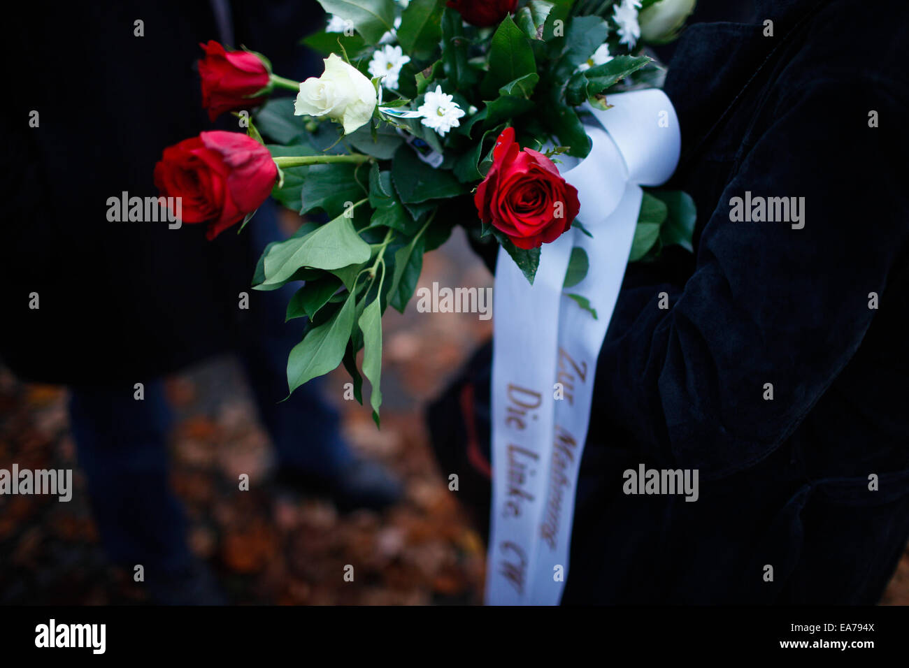 Berlin, Germany. 7th Nov, 2014. People holding flowers gather near Berlin's Grunewald train station to attend a memorial activity for the Crystal Night in Berlin, Germany, on Nov. 7, 2014. Some 100 middle school students and students from the local police school took part in the memorial activity on Friday to commemorate the 76th anniversary of the Nazi's 'Kristallnacht' (Crystal Night, Night of Broken Glass) in 1938, at Berlin's Grunewald train station, one of the major sites of deportation of the Berlin Jews during World War II. Credit:  Zhang Fan/Xinhua/Alamy Live News Stock Photo