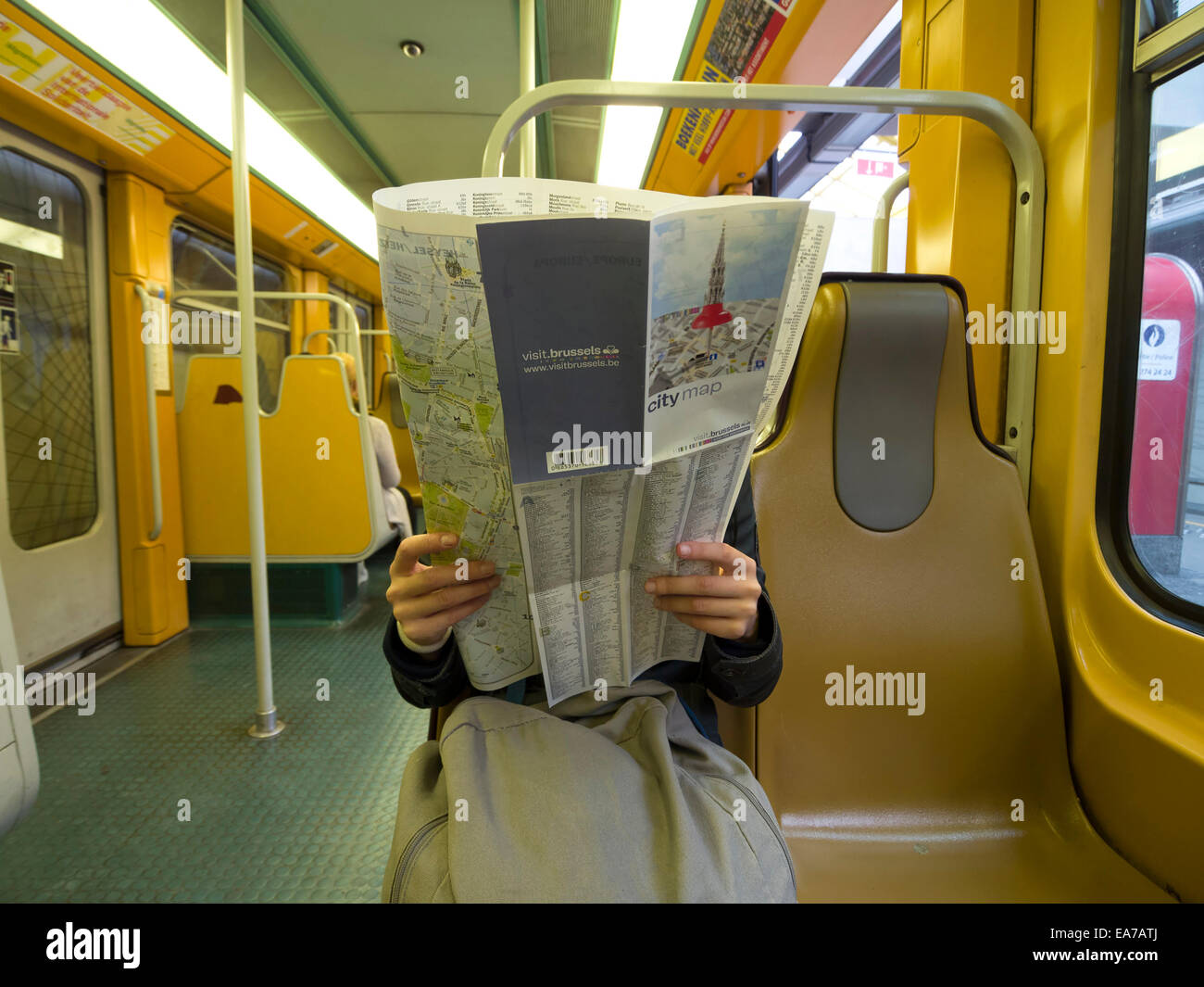 Tourist looking at a city map of Brussels while riding the subway Stock Photo