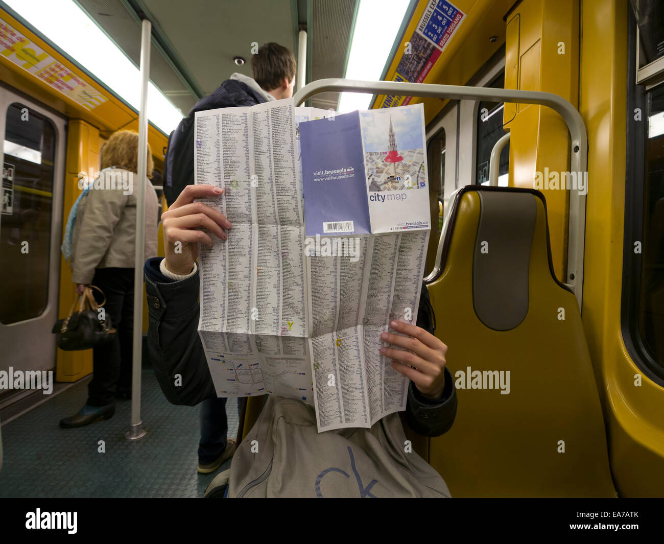 Tourist looking at a city map of Brussels while riding the subway Stock Photo
