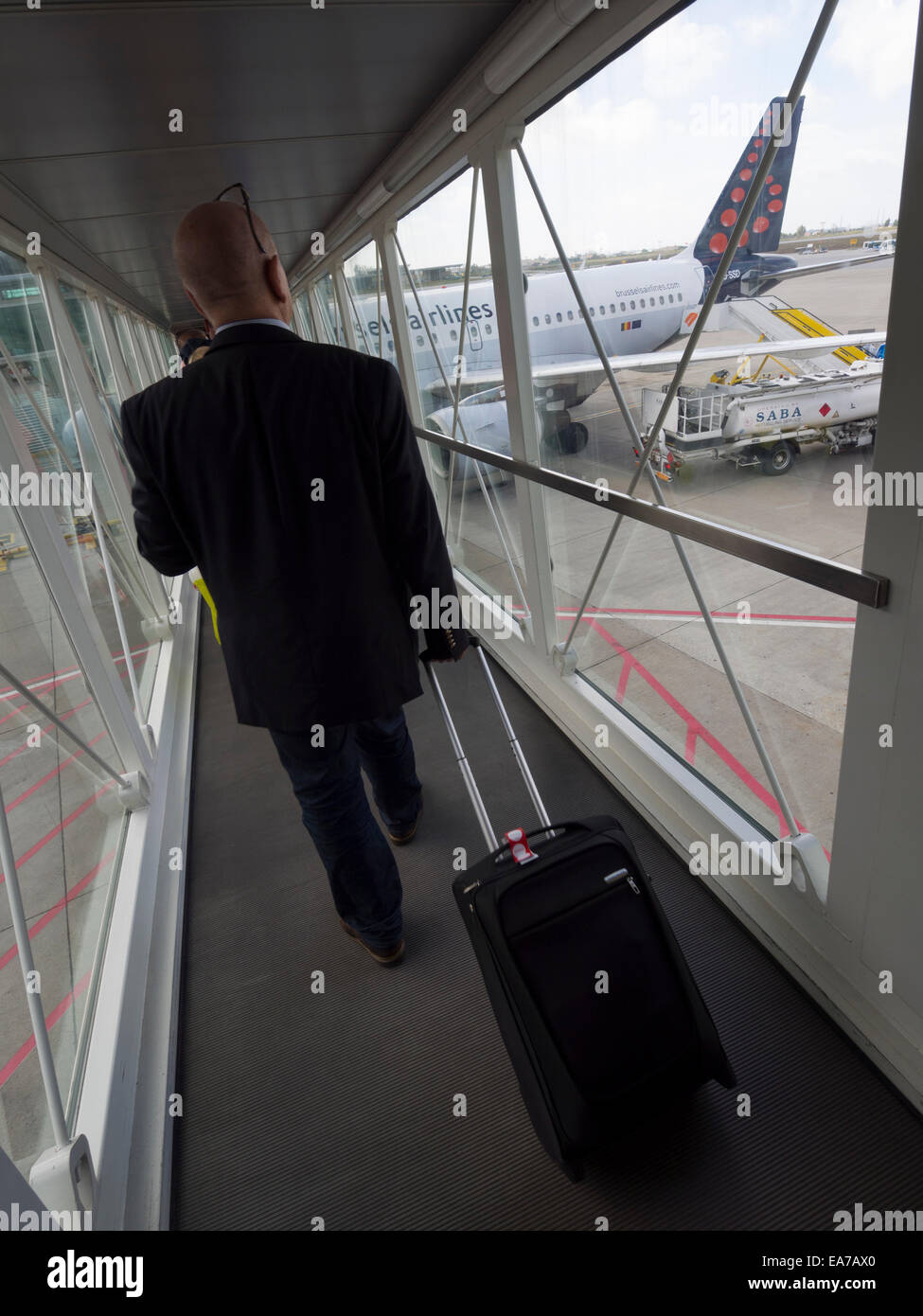 Passenger with suitcase boarding a Brussels Airlines Airbus A319-112 airplane Stock Photo