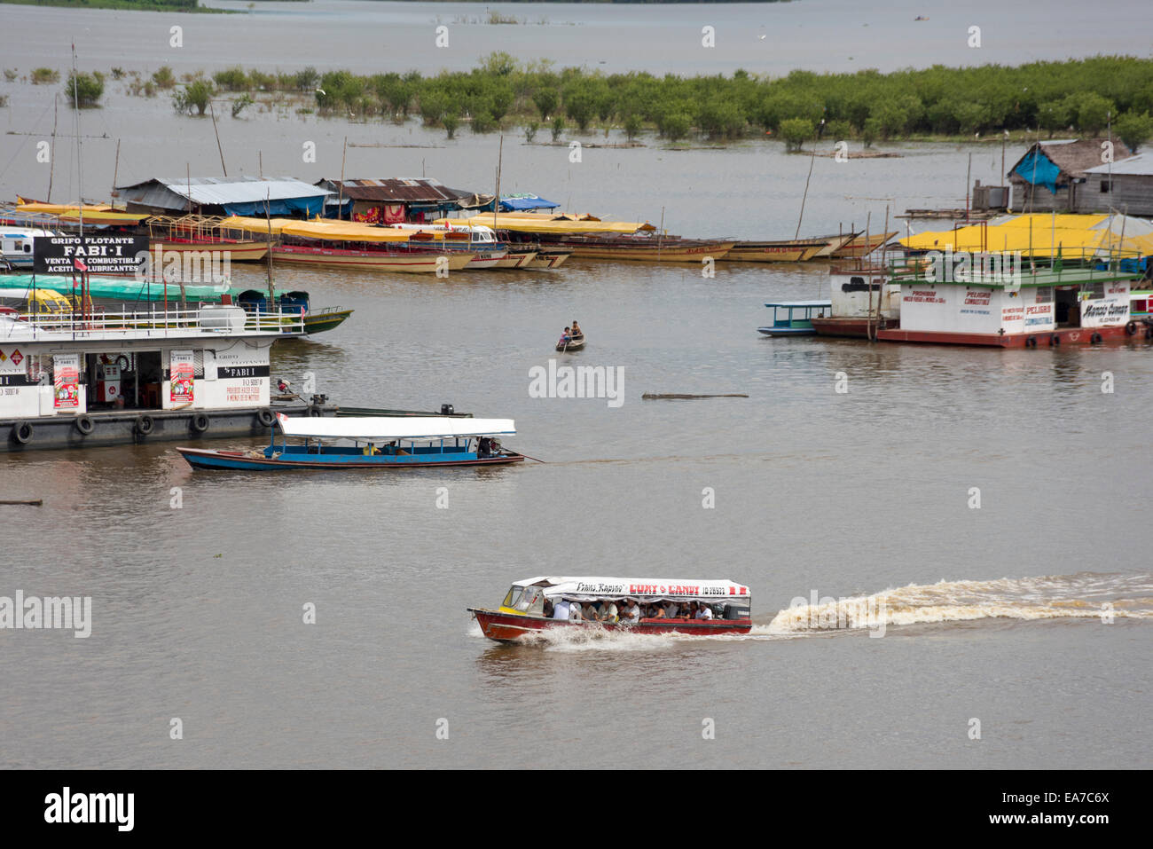 Collectivo speed boat leaving port 'Mercado de los Productores' on the Itaya River, Amazon, Iquitos, Peru Stock Photo