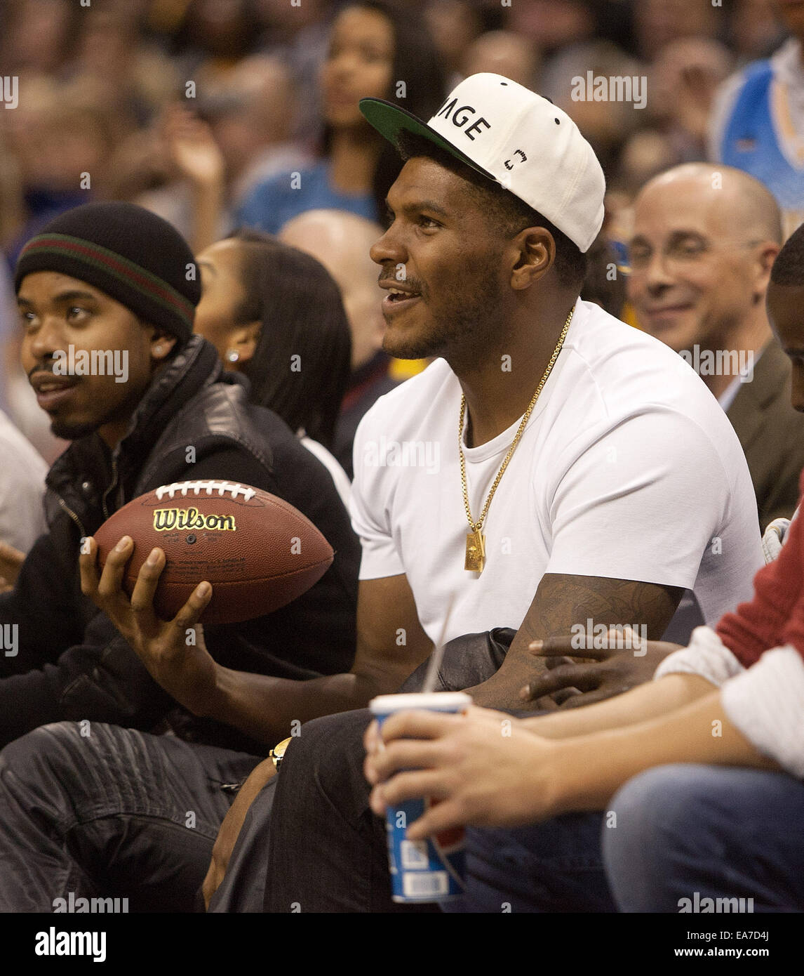 Denver, Colorado, USA. 7th Nov, 2014. Broncos TE JULIUS THOMAS gets a football from Nuggets mascot Rocky to autograph before launching it into the crowd during the 1st. half at the Pepsi Center Fri. night. The Cavaliers beat the Nuggets 110-101. Credit:  Hector Acevedo/ZUMA Wire/Alamy Live News Stock Photo