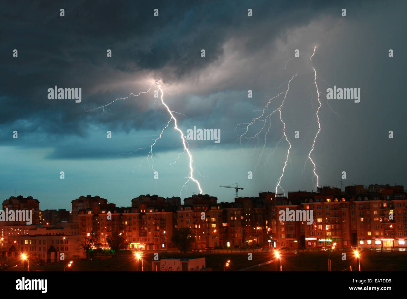 Lightning over night city during a lightning storm Stock Photo - Alamy