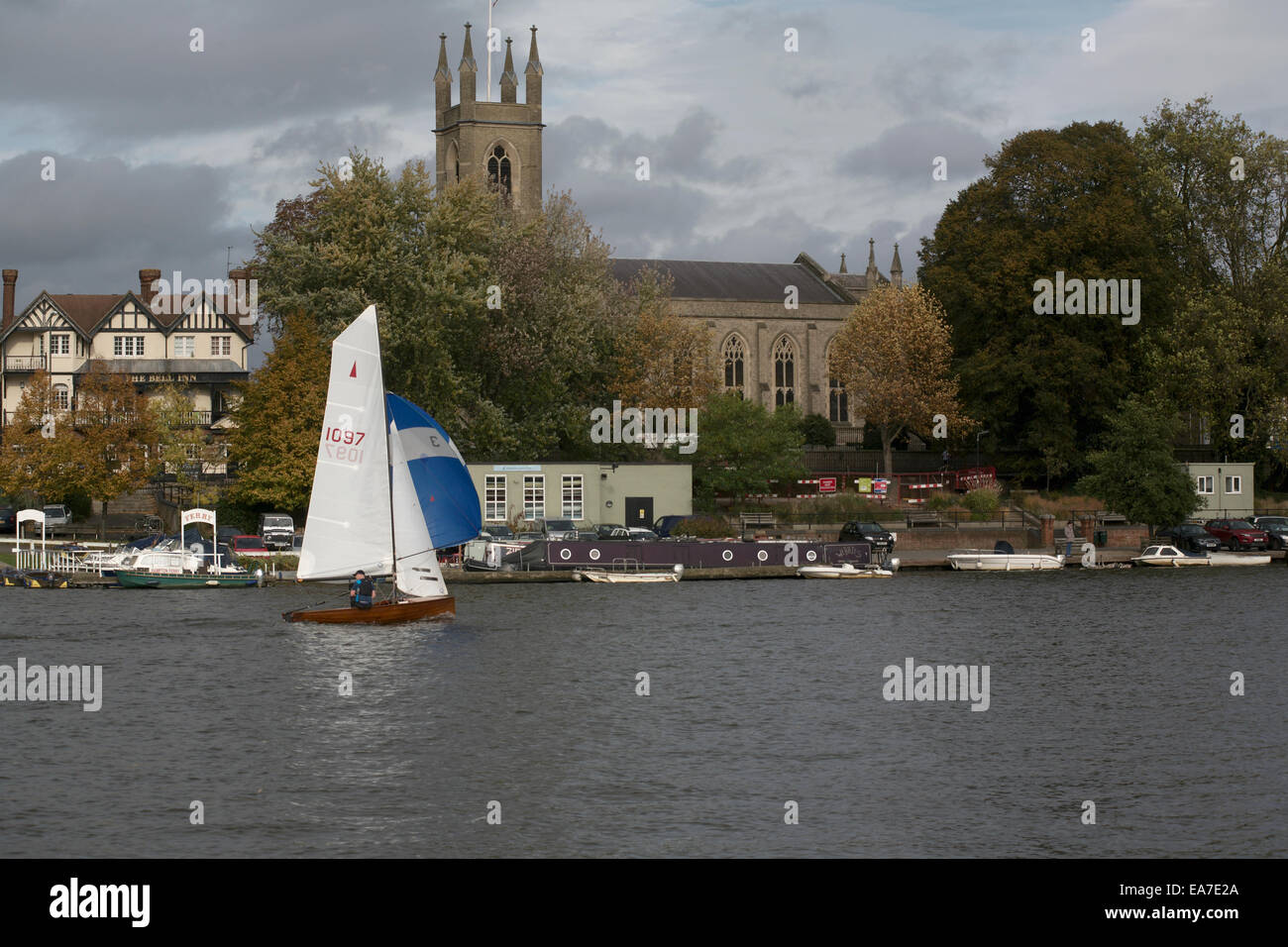 River Thames with Merlin Rocket sailing dinghy St Mary's church spire Hampton Stock Photo