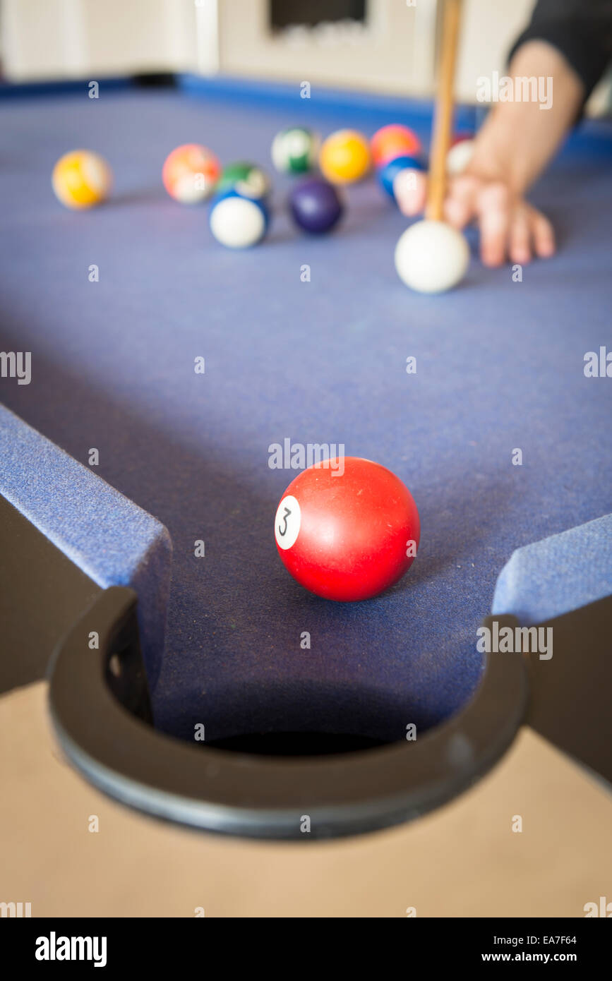 Playing pool on a pool table with billiard balls Stock Photo