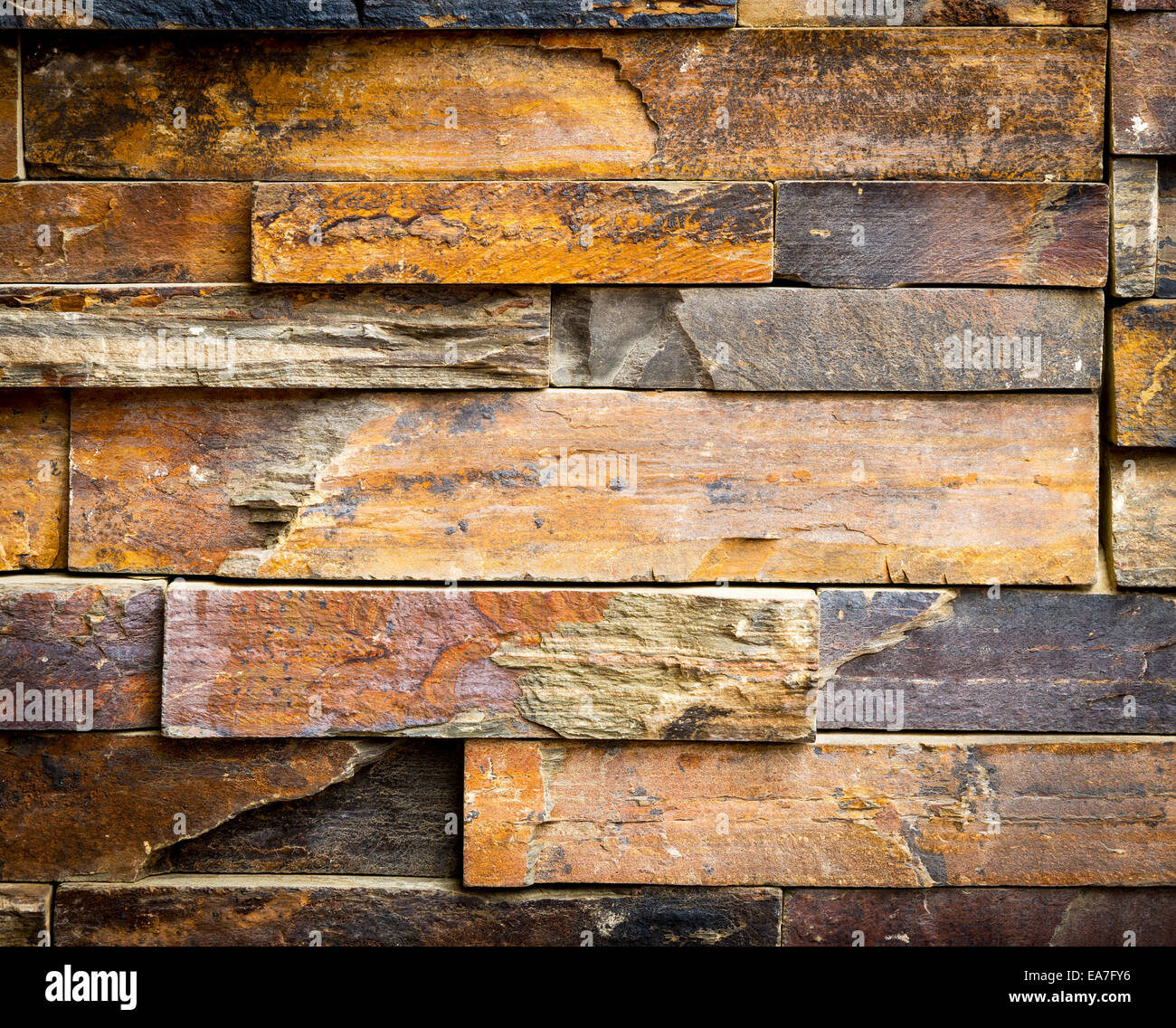 Stacked stone cladding building facade for background texture Stock Photo