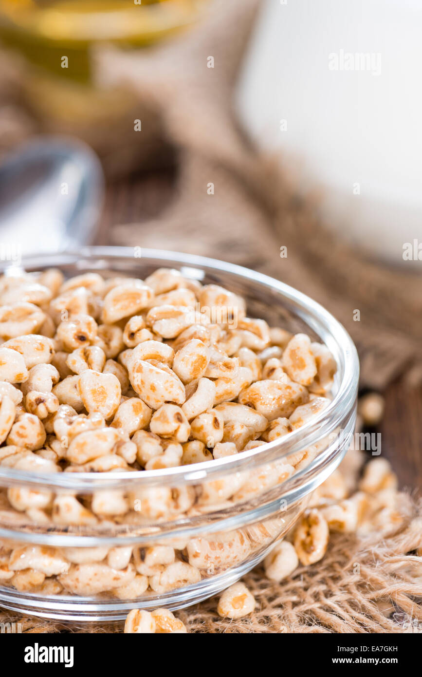 Bowl with puffed wheat, honey and milk (close-up shot) Stock Photo