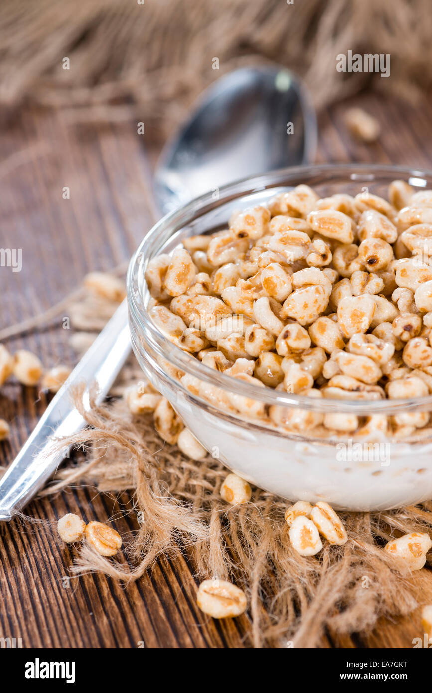 Bowl with puffed wheat, honey and milk (close-up shot) Stock Photo