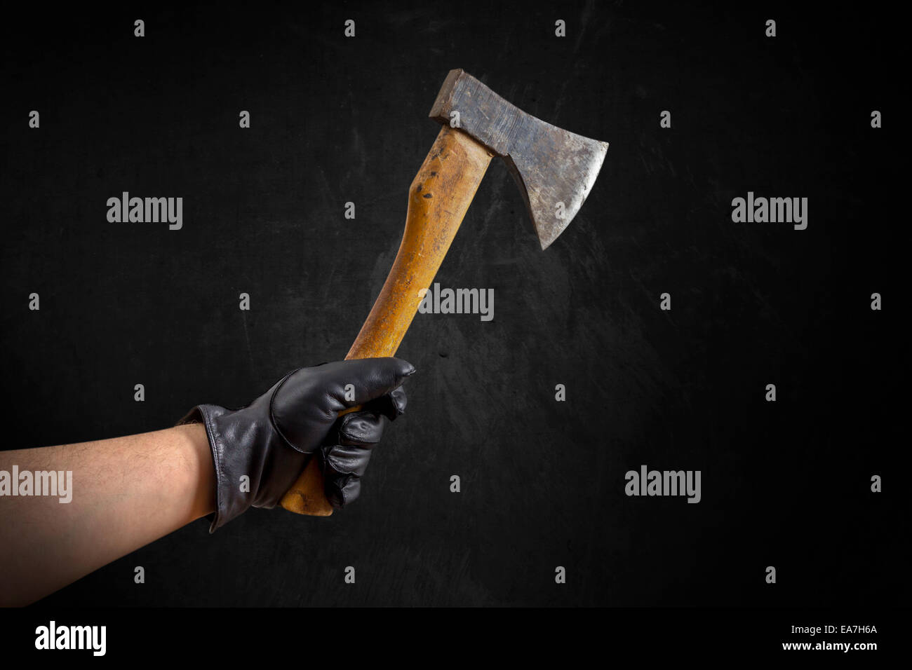 An Arm with black leather gloves holding a small axe Stock Photo Alamy