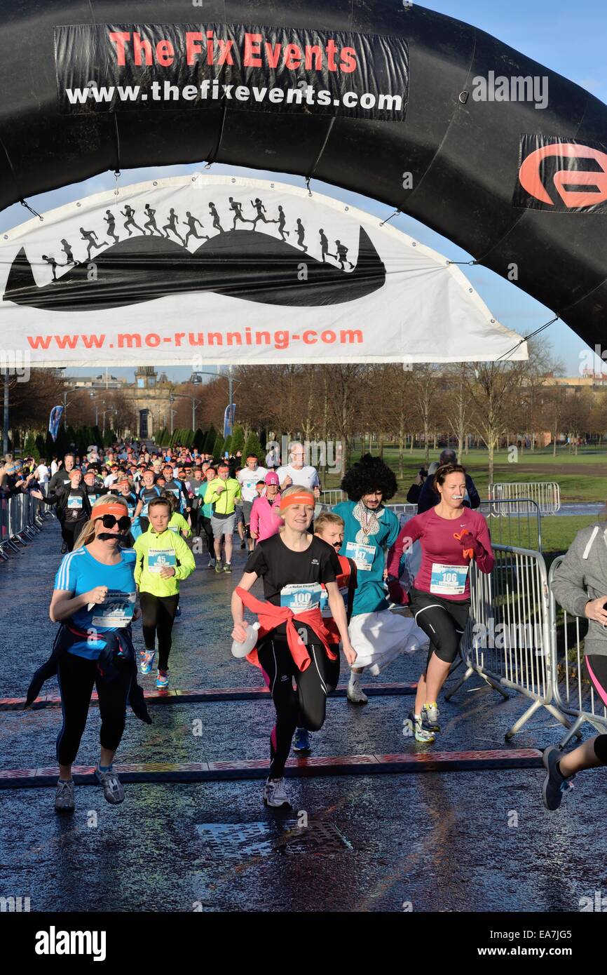Glasgow, Scotland, UK. 8th Nov, 2014. Runners in the Movember, mens health awareness fun run in Glasgow Green. Stock Photo