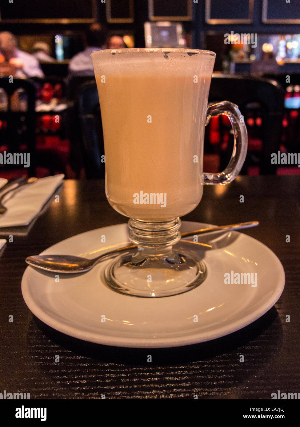 Tall Latte, close up image depicting hot latte coffee in a glass tumbler. Stock Photo