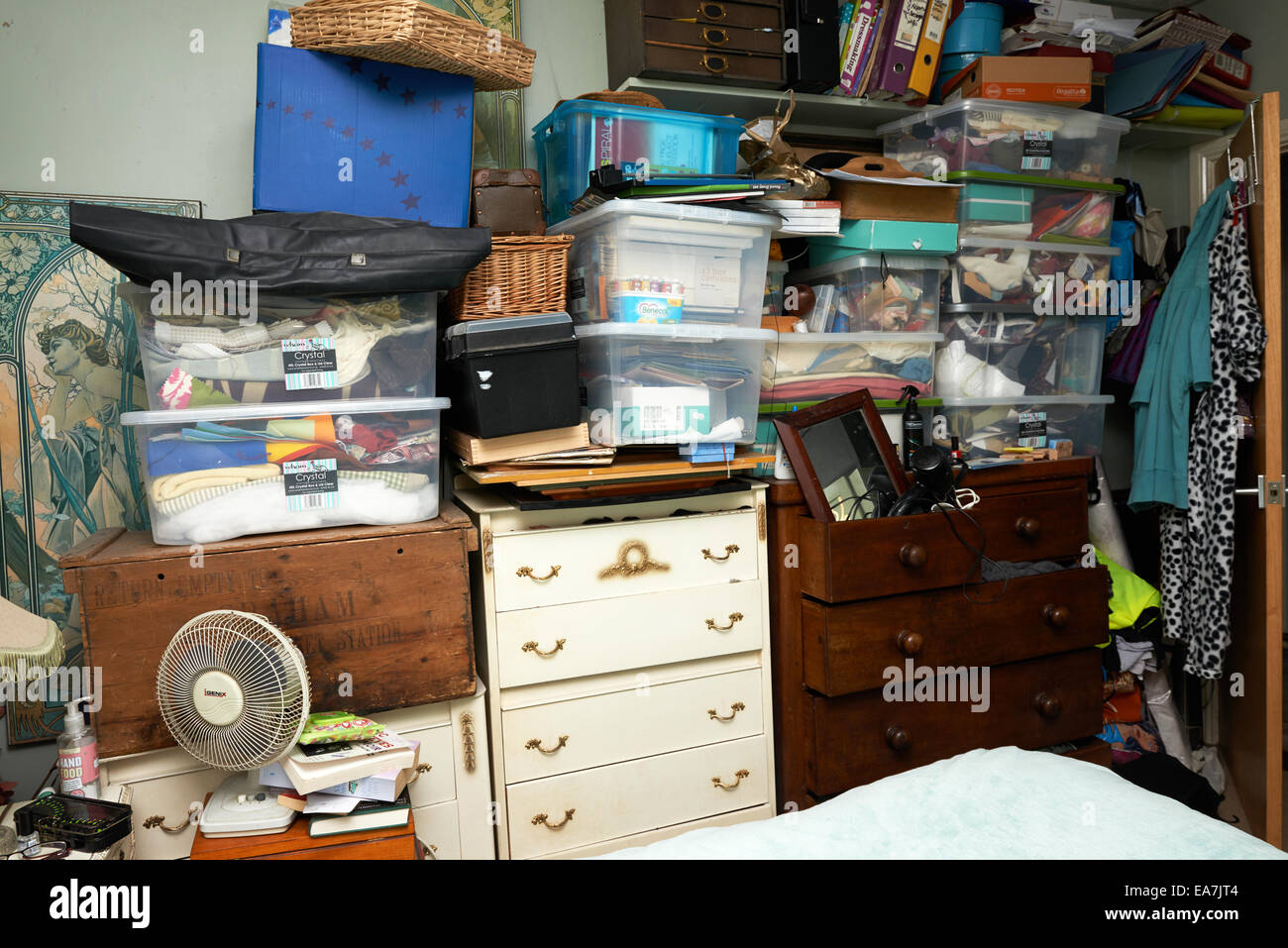 Womans bedroom filled with clutter Stock Photo