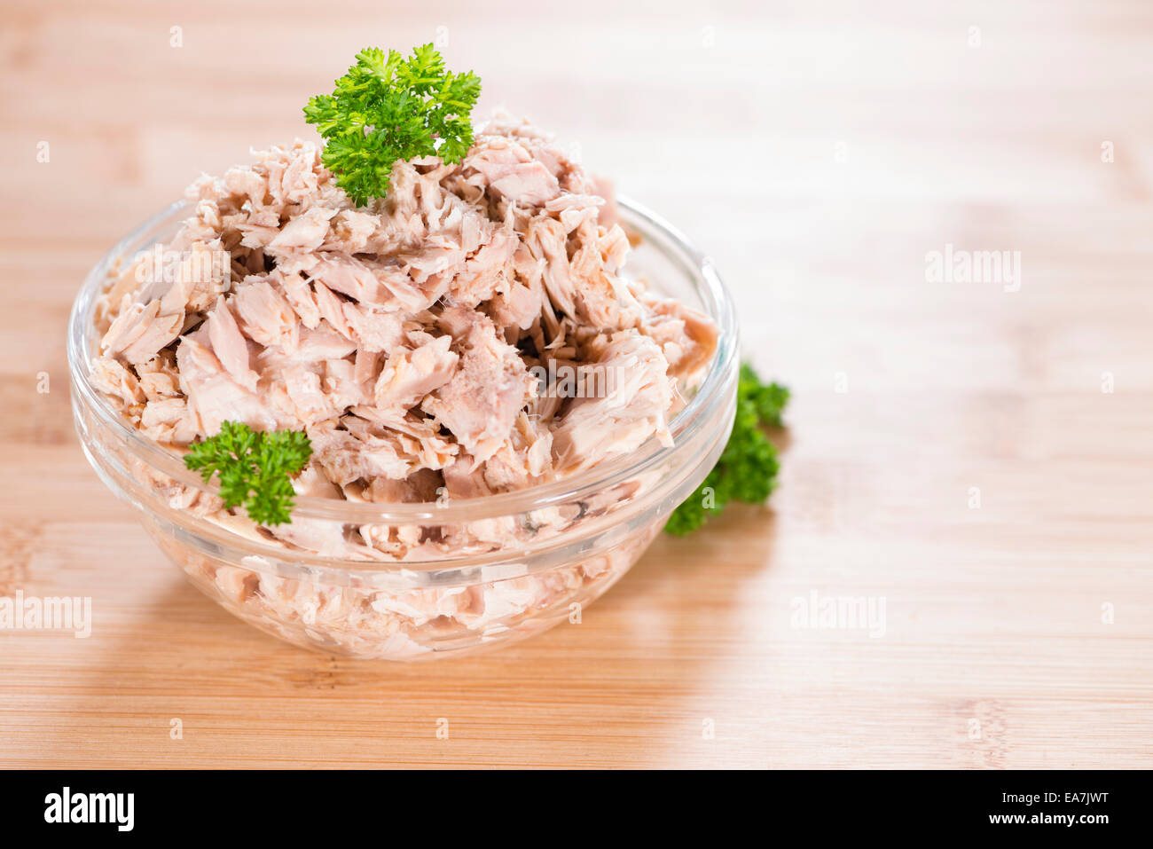 Portion of Tuna with fresh parsly on wooden background Stock Photo