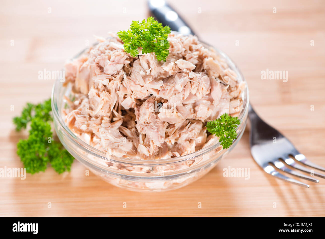 Portion of Tuna with fresh parsly on wooden background Stock Photo