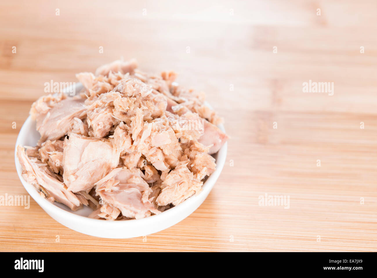 Portion of (canned) Tuna with fresh herbs as detailed close-up shot Stock Photo