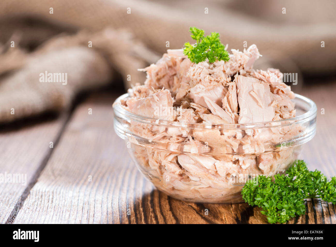 Portion of (canned) Tuna with fresh herbs as detailed close-up shot Stock Photo
