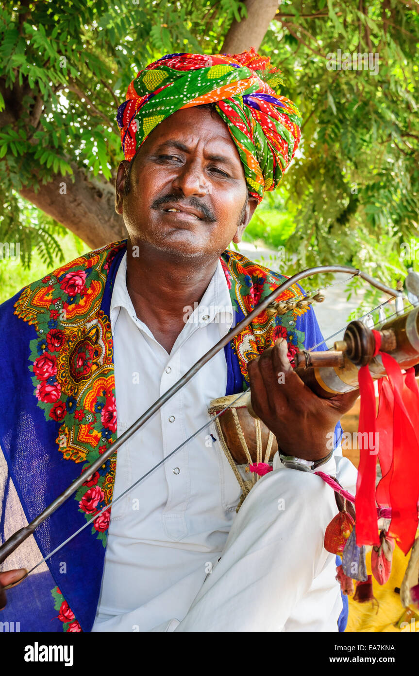 Folk musician playing traditional string instrument at Jaswant thada